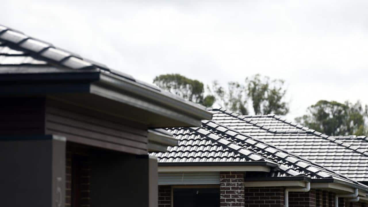 Roofs of new properties line the street in a new housing precinct in Sydney on Sunday, May 3, 2015. (AAP Image/Paul Miller) NO ARCHIVING