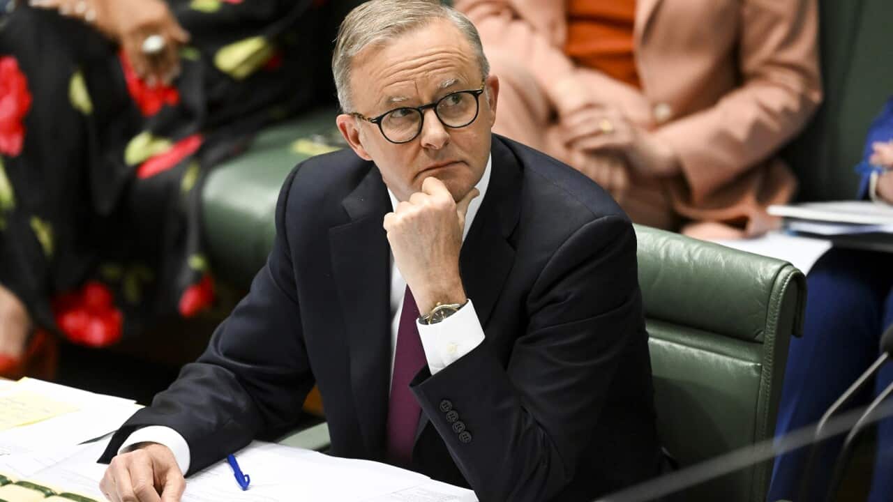 Prime Minister Anthony Albanese sits at Parliament with a notepad and pen at the last Question Time of 2022