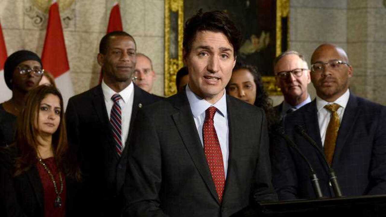 Canada's Prime Minister Justin Trudeau speaks with media during an availability in the foyer with his caucus on Parliament Hill, in Ottawa on Tuesday, January 30, 2018.