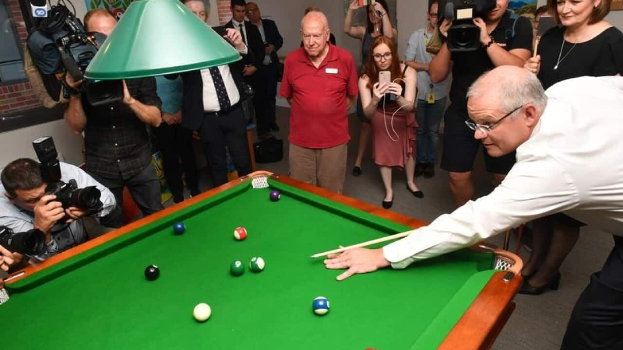 Prime Minister Scott Morrison plays pool on the campaign trail.