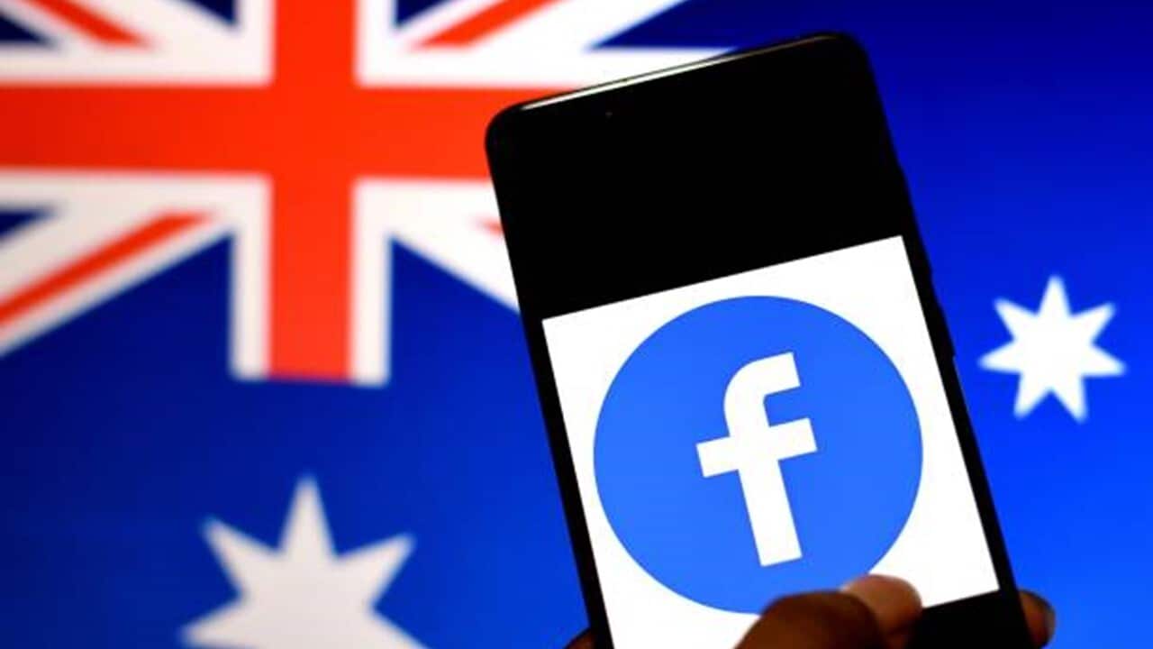 The Facebook logo seen displayed on a Smartphone with an Australian flag in the background.