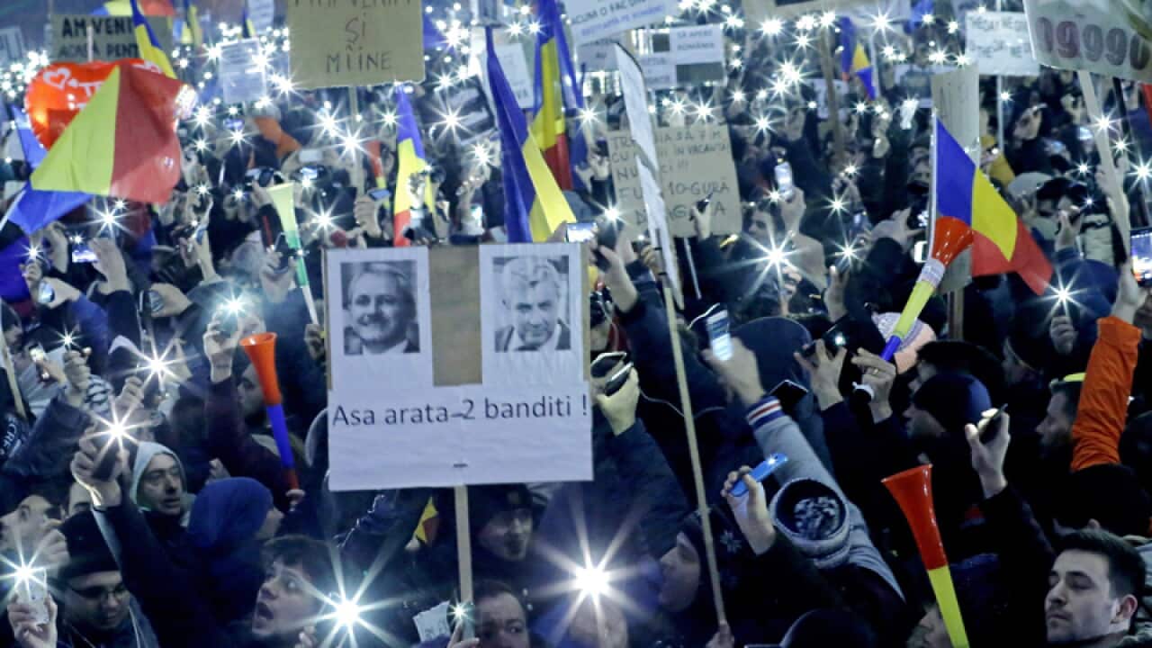 People protest in front of government headquarters in Bucharest
