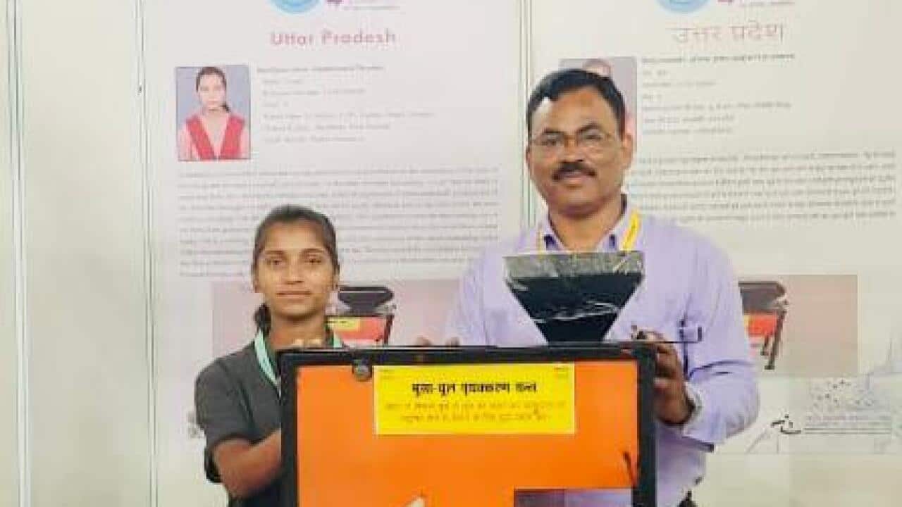 Puja and her teacher with Thresher Model.jpeg