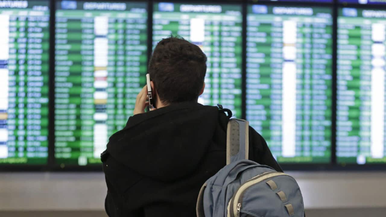A traveller speaks on the phone at San Francisco Airport