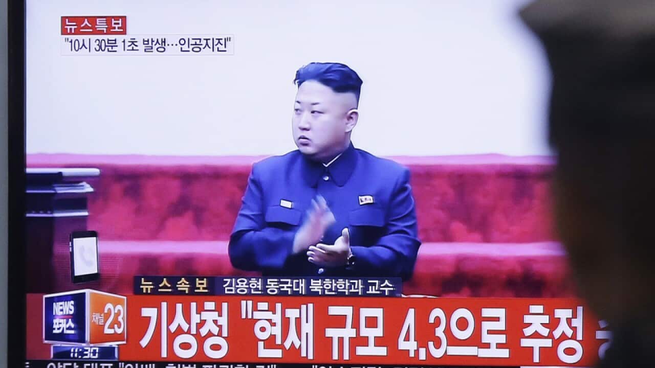 A TV screen showing a file image of North Korean leader Kim Jong Un