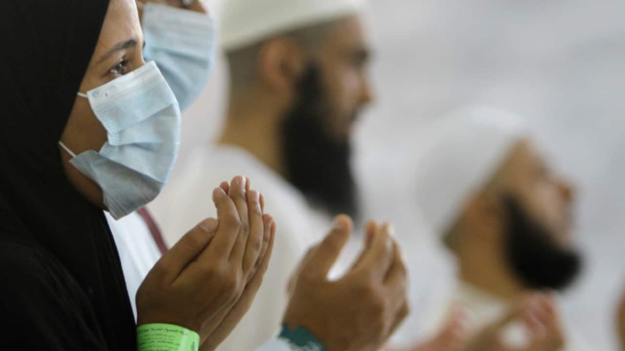 Egyptian Muslim pilgrims wear masks as a precaution