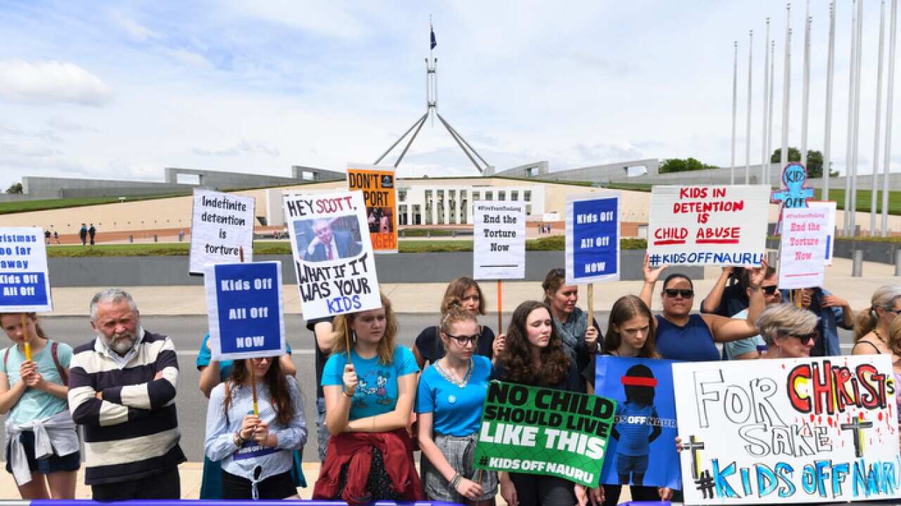 Protesters demanding the resettlement of kids held on Nauru outside Parliament House in Canberra in November