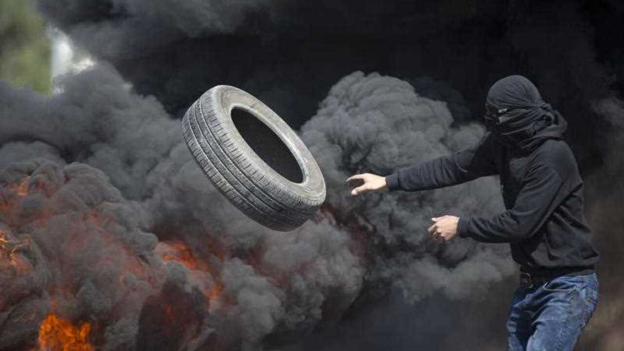 Palestinians burn tires during clashes with Israeli troops near Ramallah, West Bank