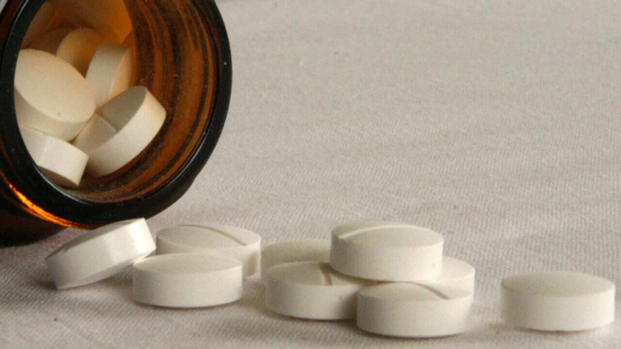 Pills fall from a bottle