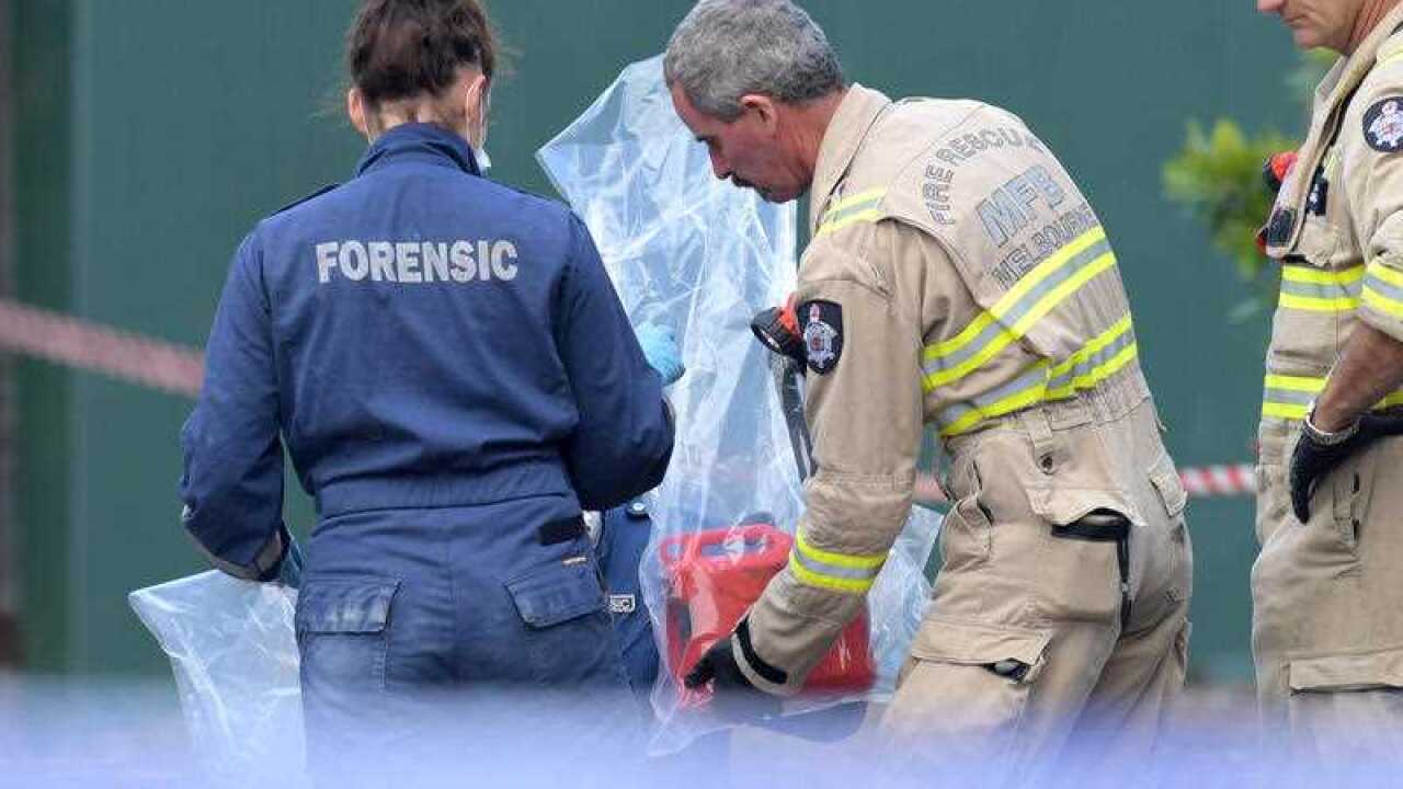Forensic officers bag a fuel bottle at the scene of a factory fire in Footscray, Melbourne, Thursday, March 2, 2017.