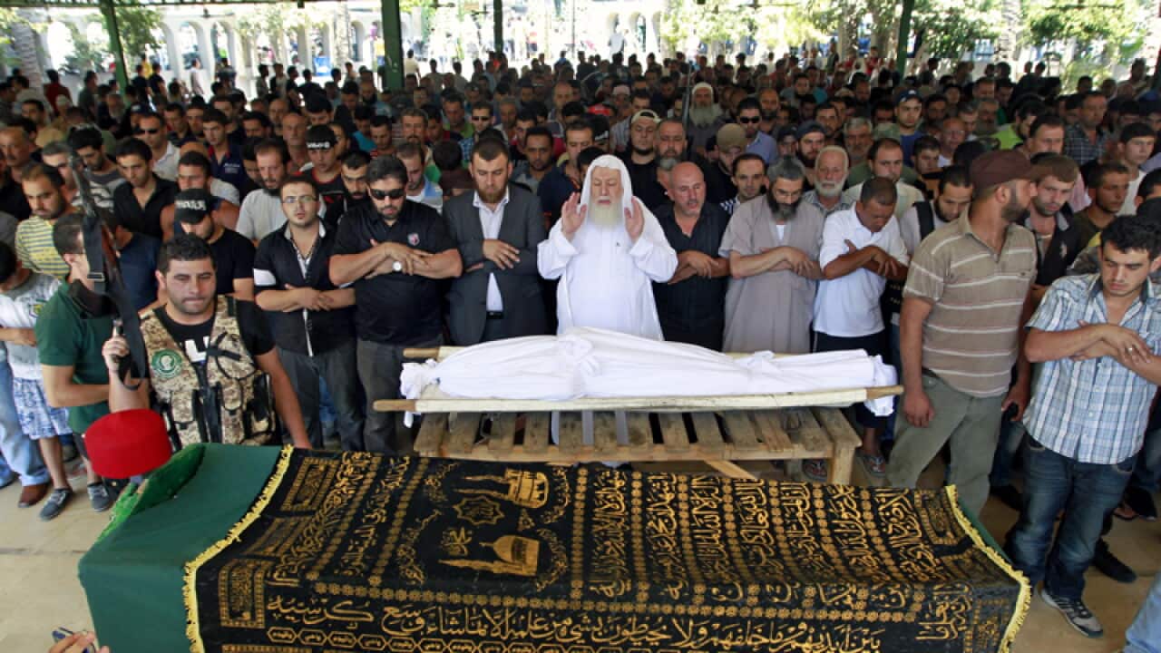 Mourners during a funeral for two men killed in bomb blast in Tripoli