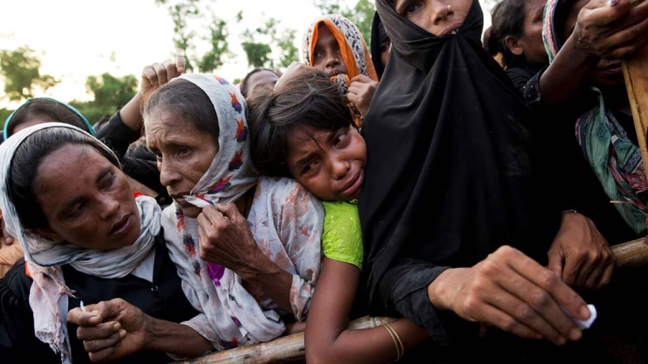 Rohingya Muslims stand to receive food being distributed near Balukhali refugee camp in Cox's Bazar, Bangladesh