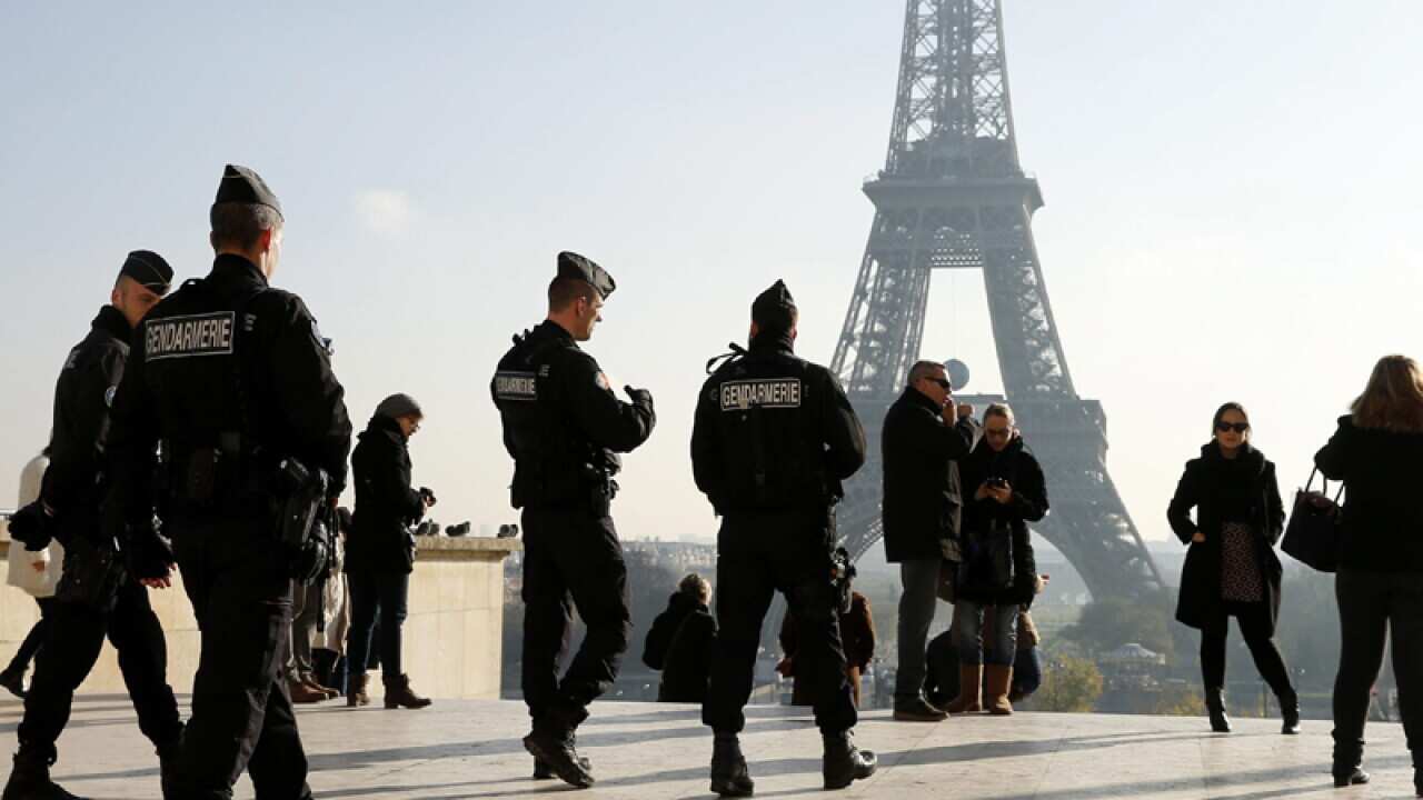 French Police officers patrol near the Eiffel Tower