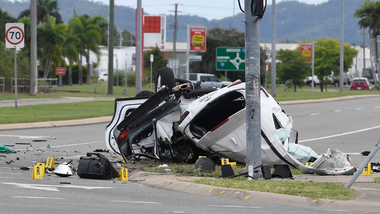 A crashed vehicle is seen laying on the road