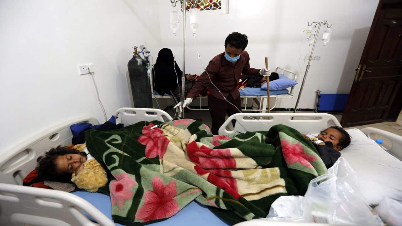Yemeni children suffering from measles share a bed as they receive medical treatment at a hospital amid a rapidly spreading measles outbreak, in Sanaa, Yemen