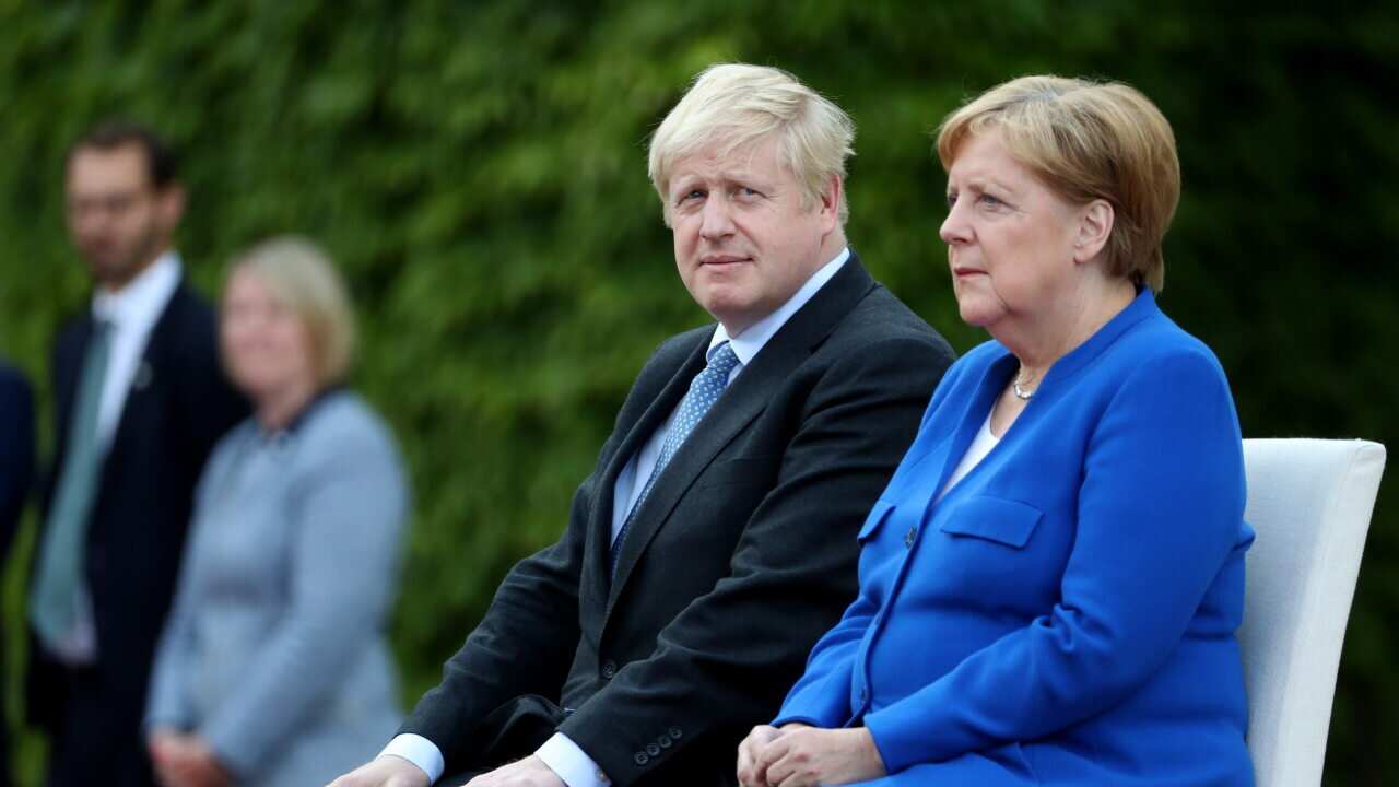 German Chancellor Angela Merkel receives British Prime Minister Boris Johnson with military honors at the Chancellery in Berlin.