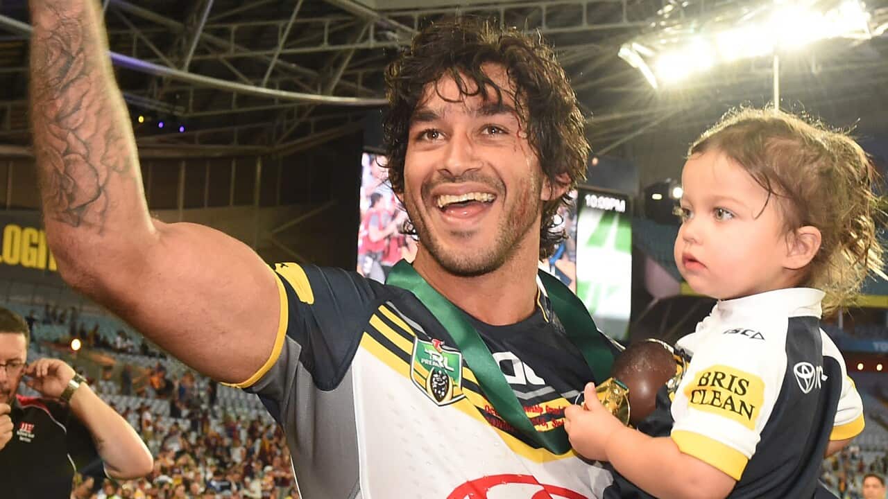Cowboys captain Johnathan Thurston with daughter Charlie celebrates after their win over the Broncos the NRL Grand Final between the Brisbane Broncos and the North Queensland Cowboys at ANZ Stadium in Sydney.