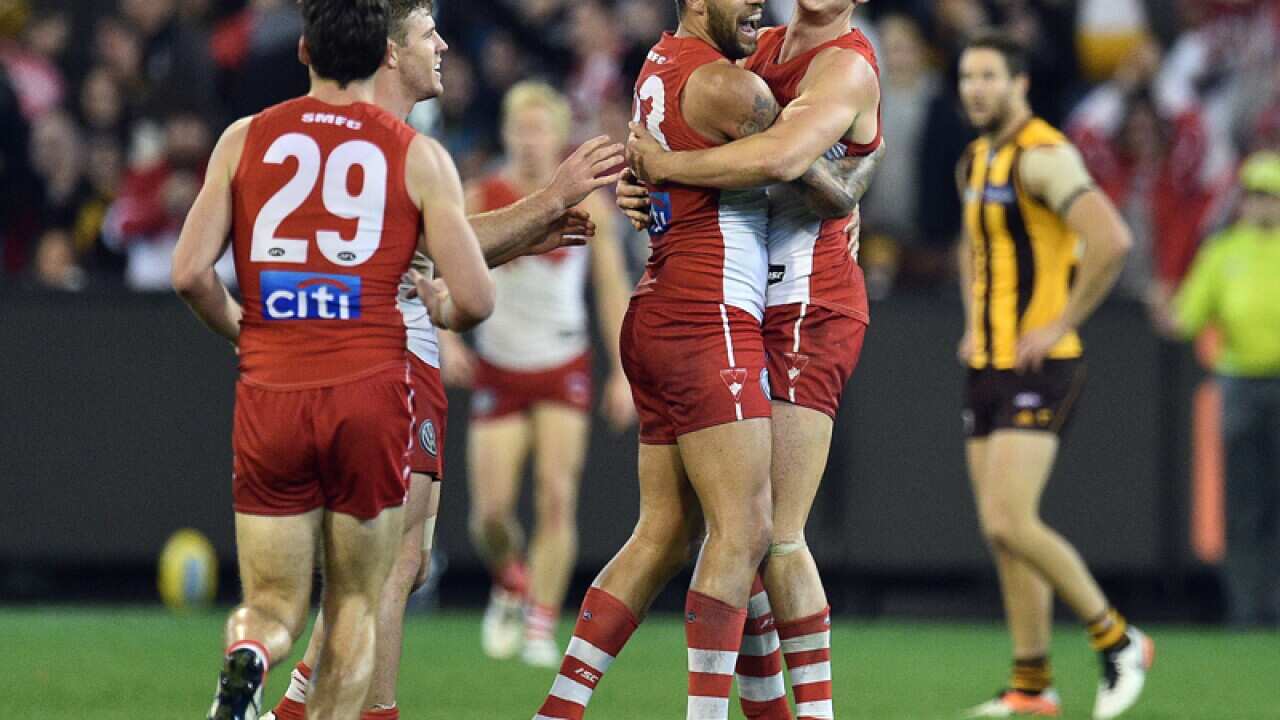 Swans players react after Lance Franklin kicked a goal