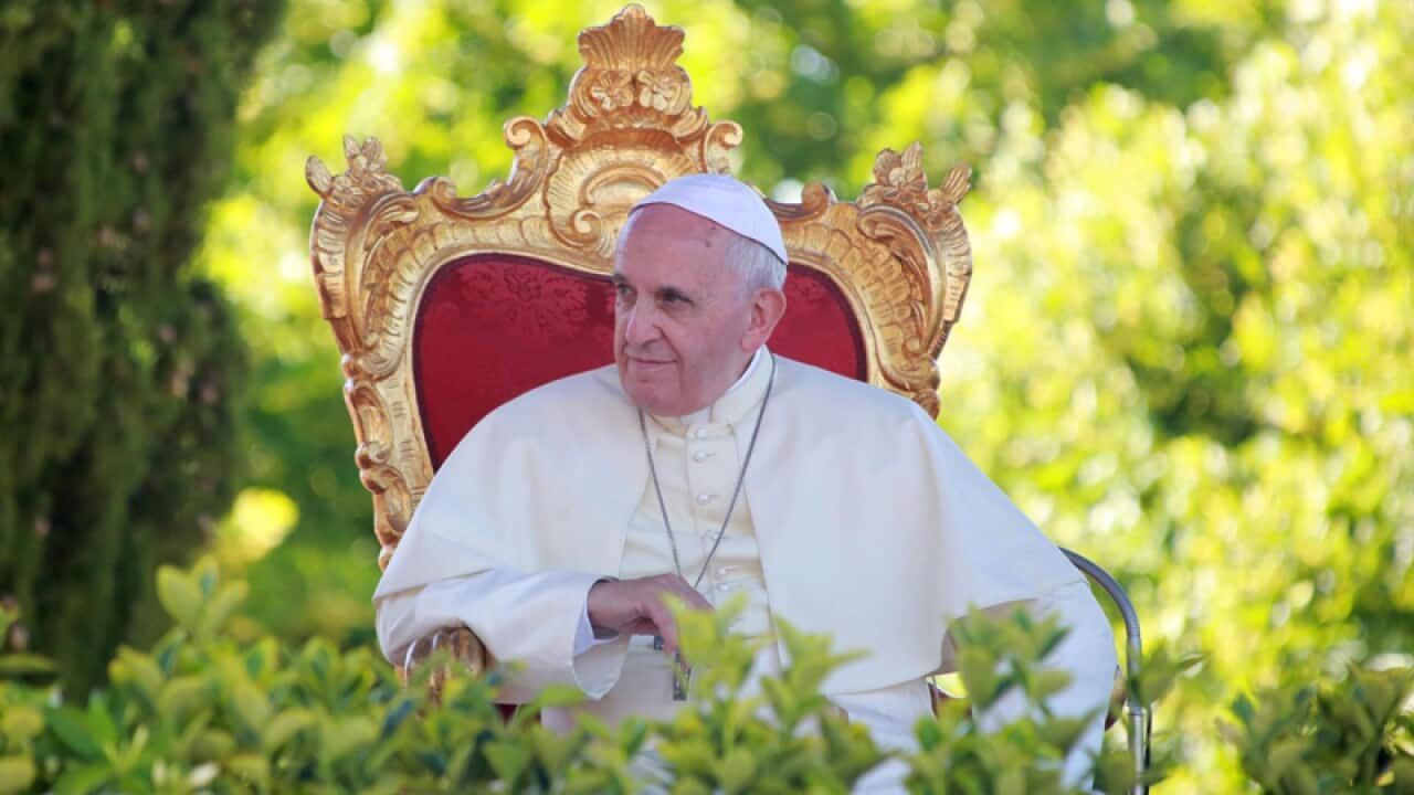 Pope Francis sits on a golden chair during his visit to Isernia, Italy