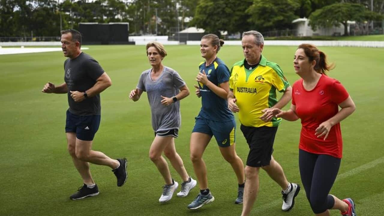 Bill Shorten running with local candidates and Australian cricketers.