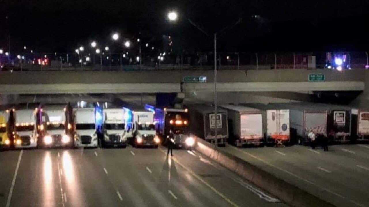 Trucks line up to help stop a suicide attempt on a freeway in the US.