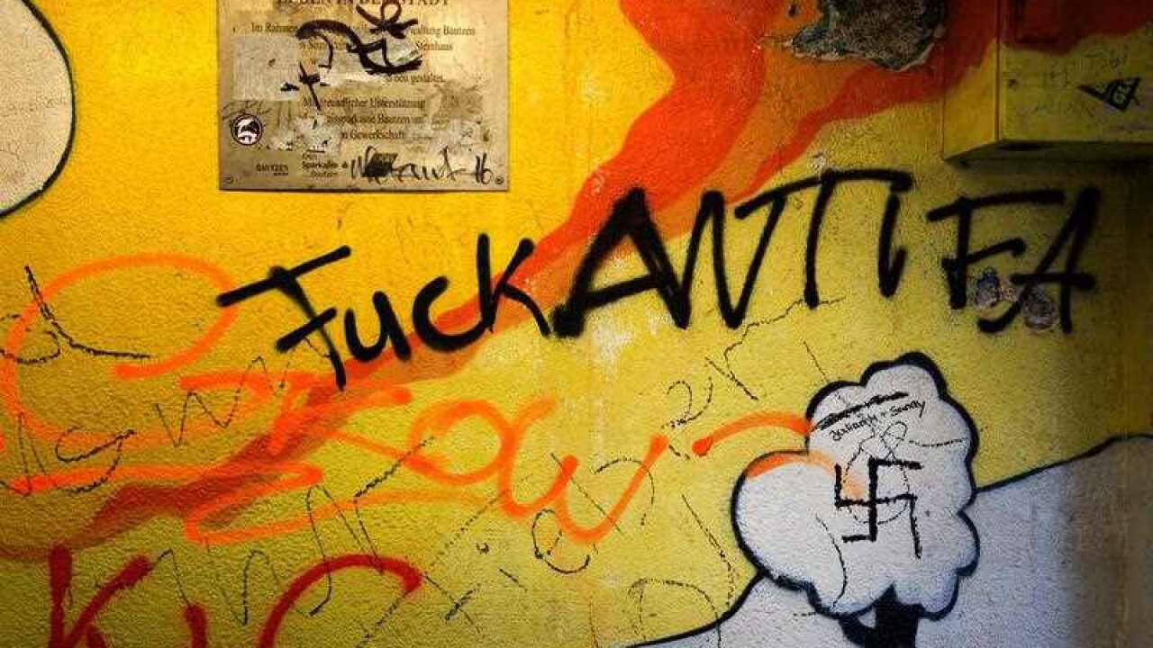 Neo-Nazi slogans and a Swastika can be seen on a wall of an underground passage at Kornmarkt square in Bautzen, Germany, 18 September 2016