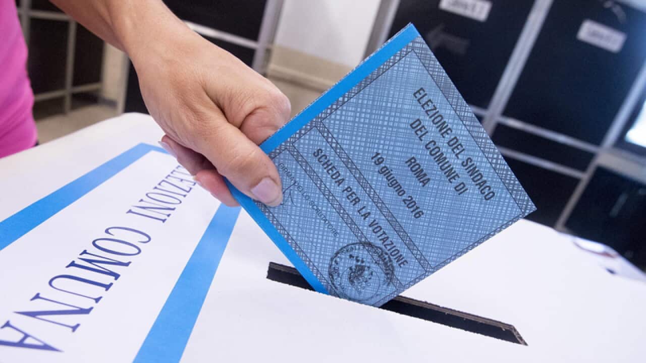 A voter casts their ballot in mayoral elections in Rome