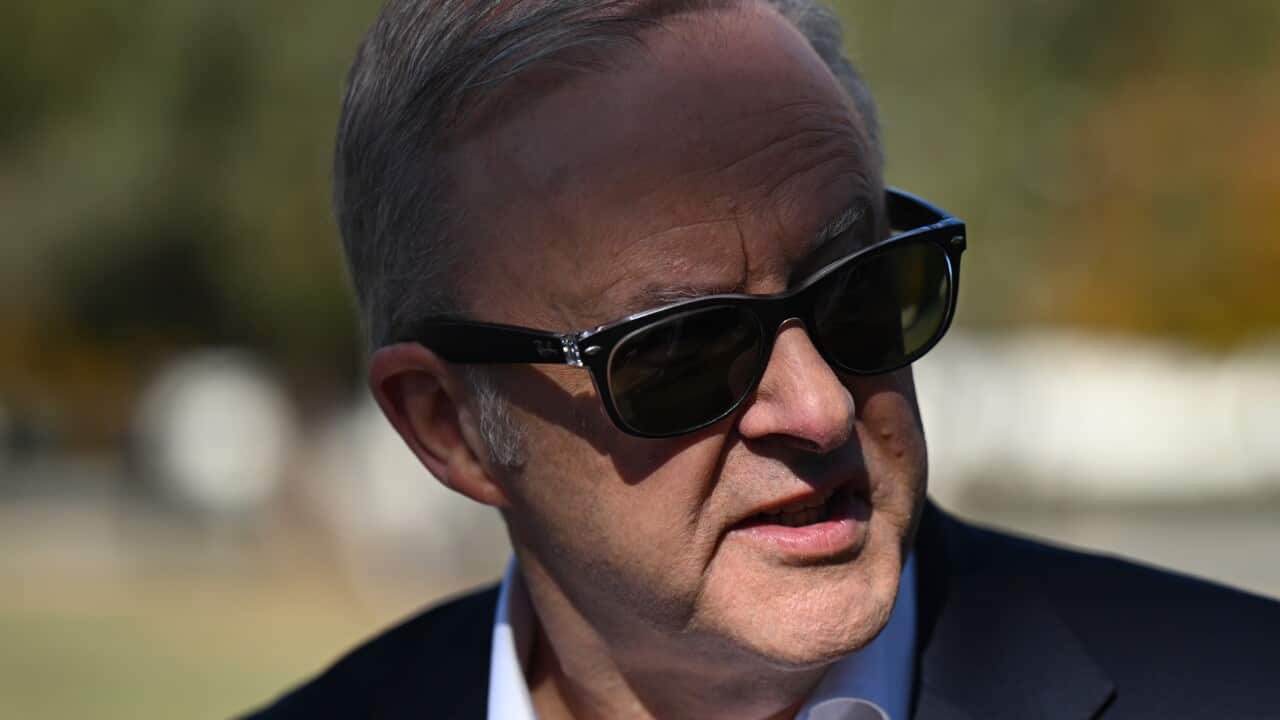 A man wearing a suit and sunglasses