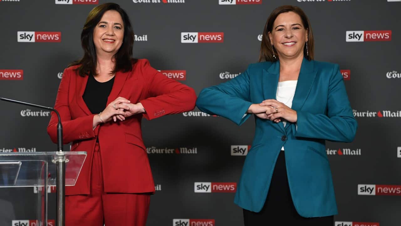 Queensland Premier Annastacia Palaszczuk (left) and opposition Leader Deb Frecklington bump elbows at the start of a People's Forum at the Broncos Leagues club in Brisbane, Wednesday, October 28, 2020.
