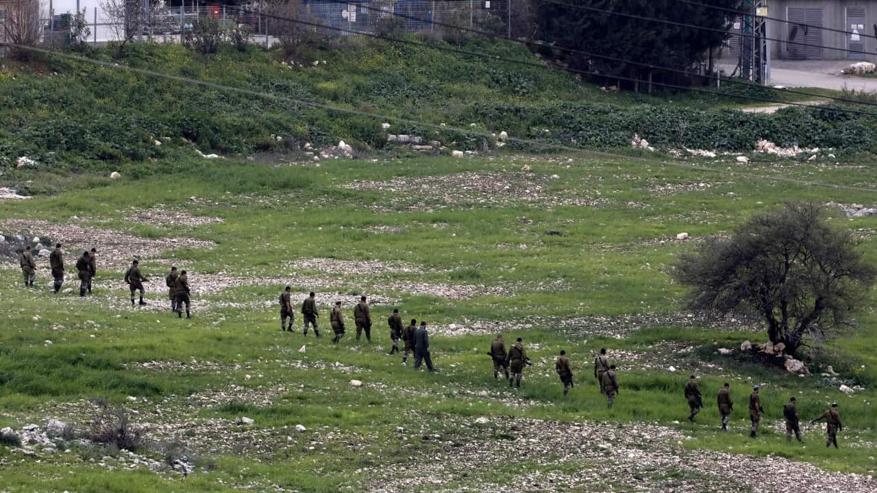 Israeli soldiers inspect the site of an Israeli F-16 fighter jet that was shot down.