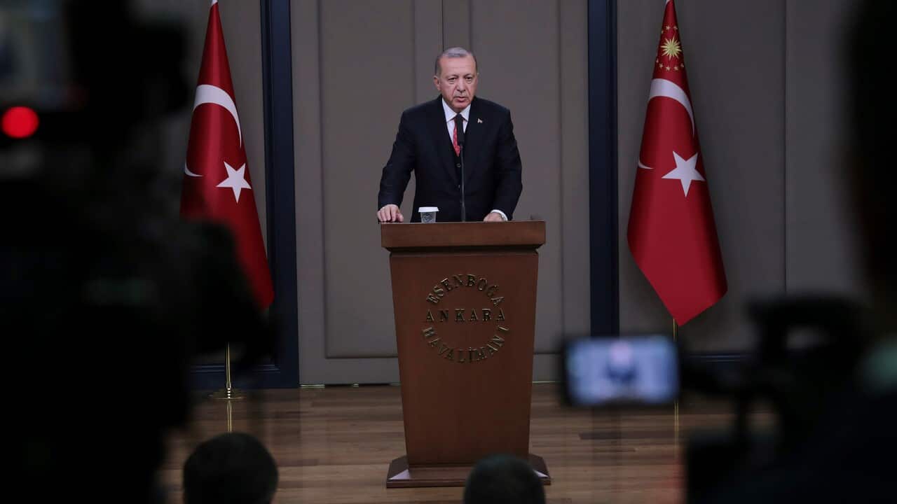 Turkey's President Recep Tayyip Erdogan talks to members of the media at the airport in Ankara, Turkey.