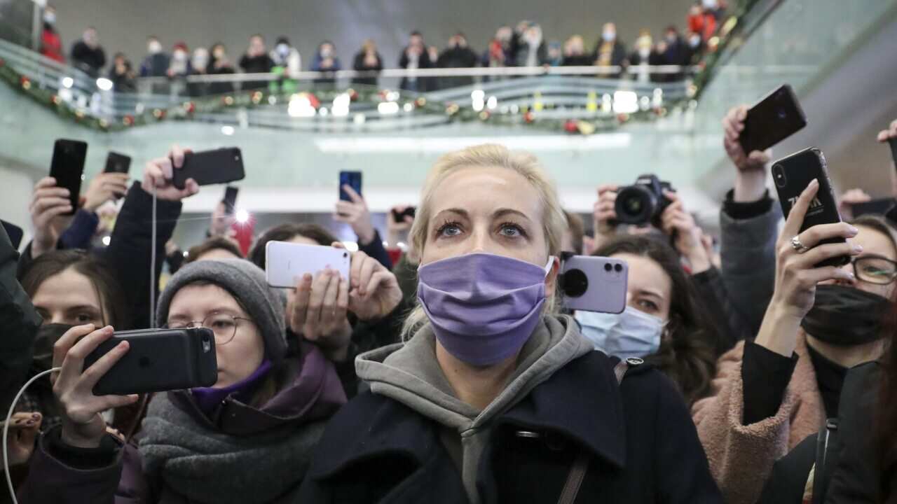 Opposition activist Alexei Navalny's wife Yulia (C) is seen at the Sheremetyevo International Airport after arriving with her husband from Berlin.