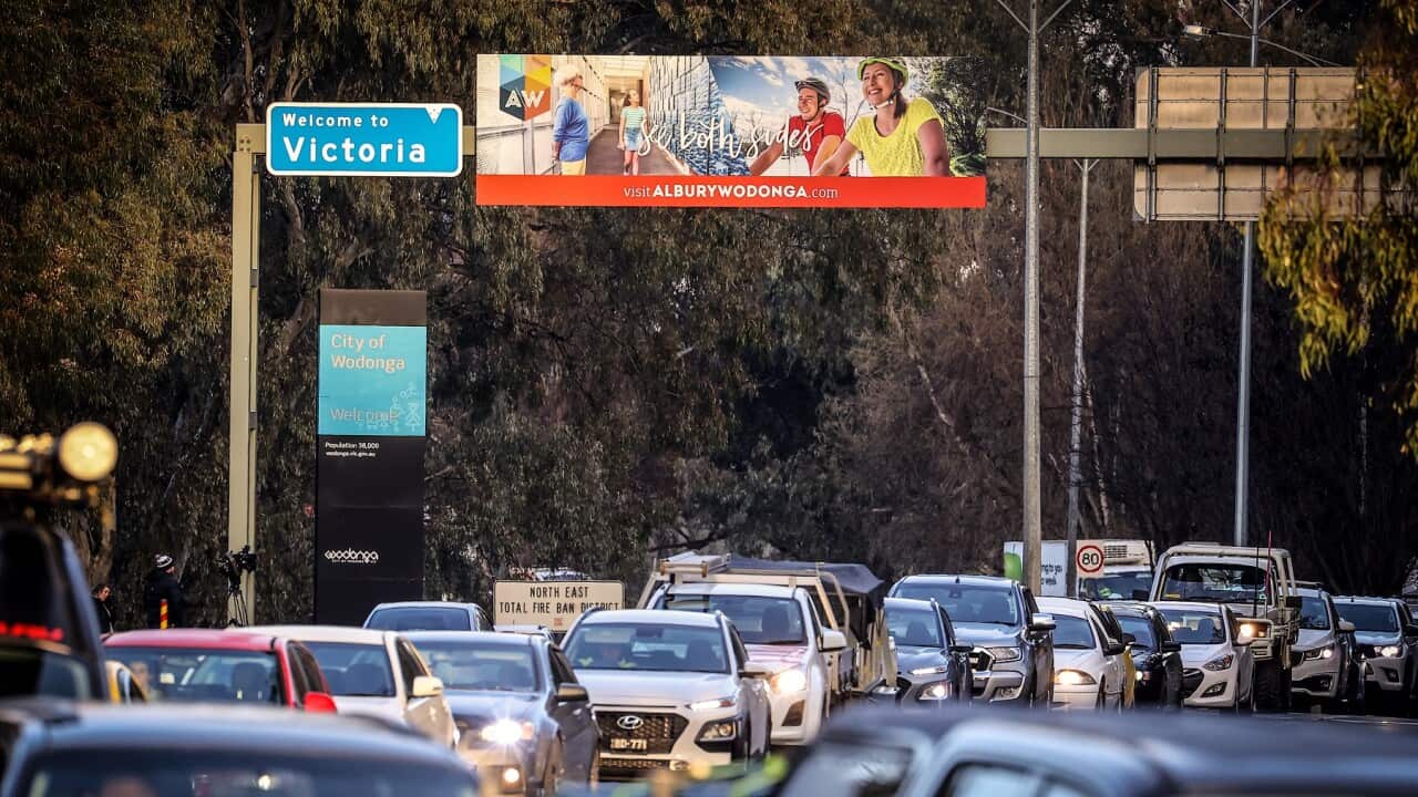Cars queue at a police checkpoint in Albury, Australia