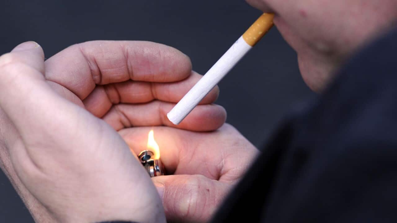 a man lighting a cigarette