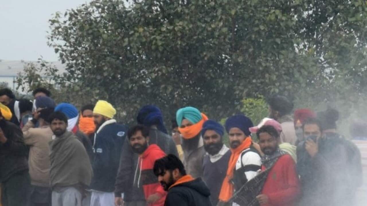 Indian police fired tear gas and water cannon when they clashed with several thousand farmers marching to New Delhi.