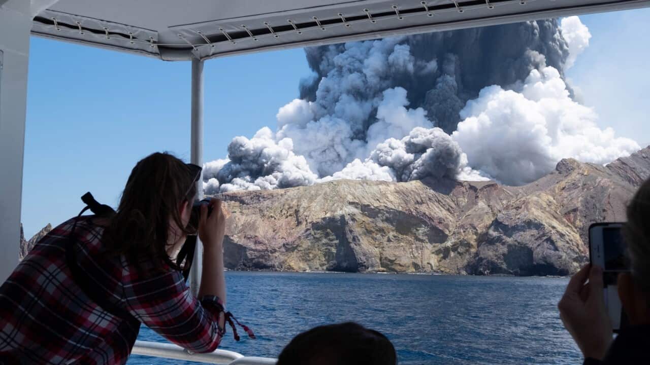 Visitors on a boat off White Island view Monday's eruption