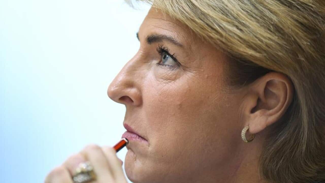 Australian Jobs Minister Michaelia Cash holds a pencil to her chin.