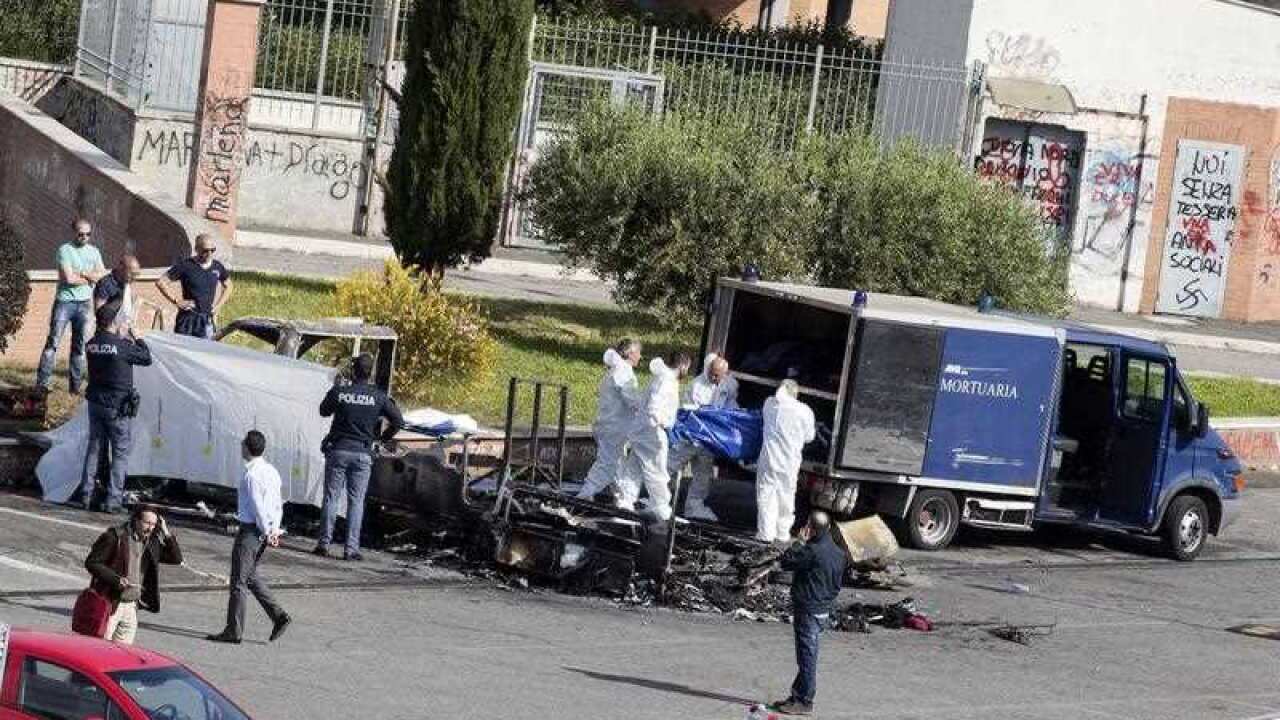 The body of a victim of the camper fire is transferred to the mortuary police van in Rome, Italy, 10 May 2017.