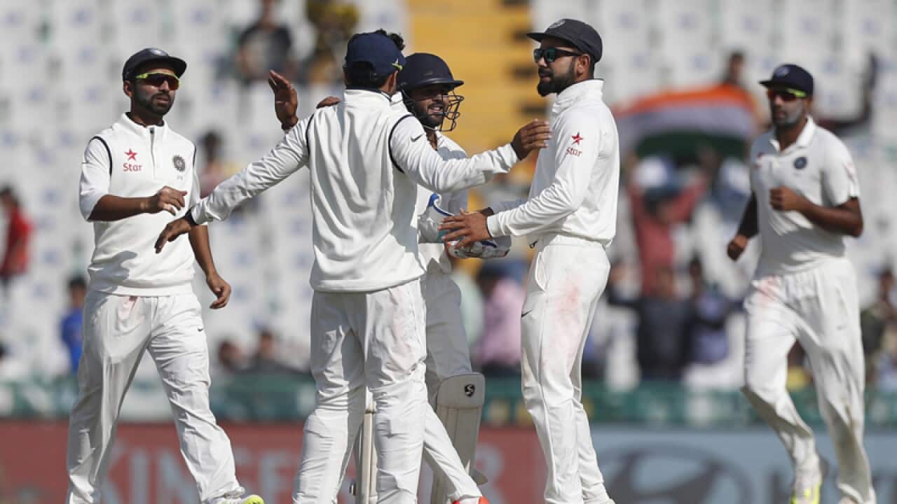 Indian team members celebrate the dismissal of England's Ben Stokes