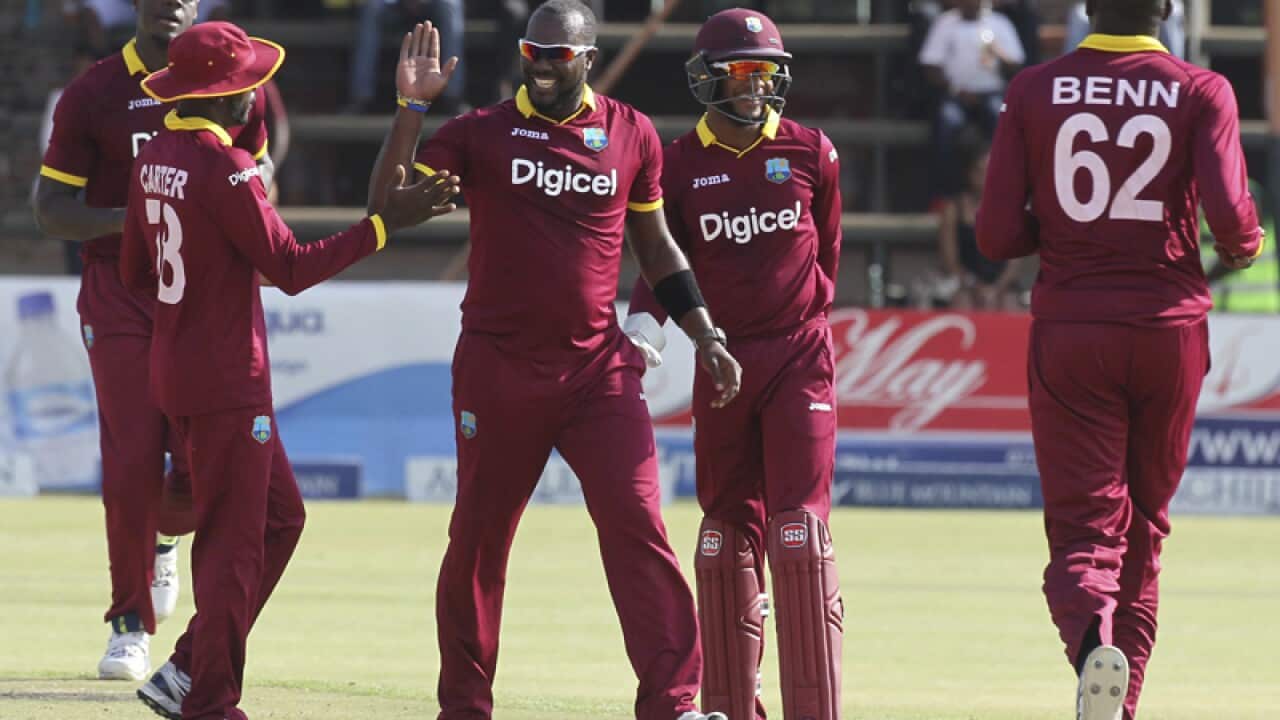 West Indies players celebrate a wicket against Sri Lanka