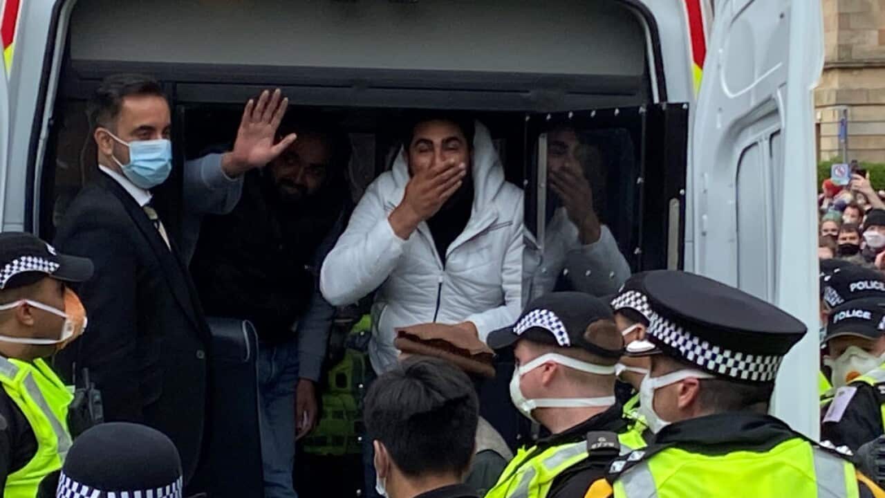 The two men after their release from the back of the immigration van