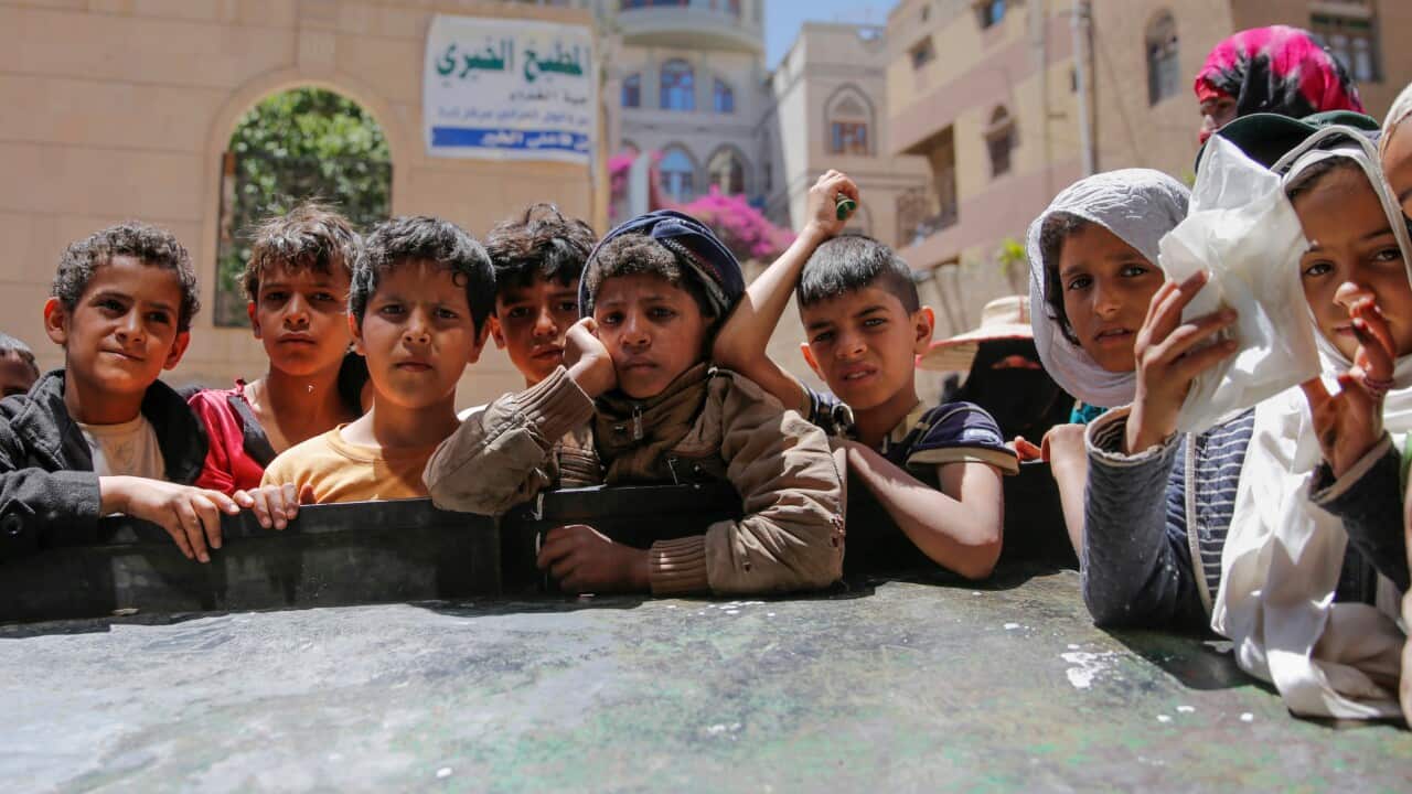 Yemeni boys and girls wait to reacts while receiving local charity-provided food rations in Sanaa, Yemen, Thursday, April, 13, 2017.