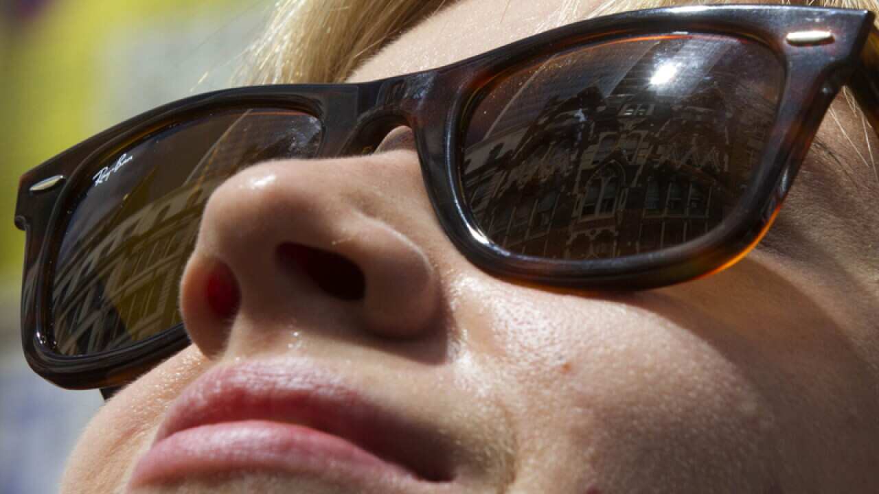 A woman wears sunglasses to protect her eyes