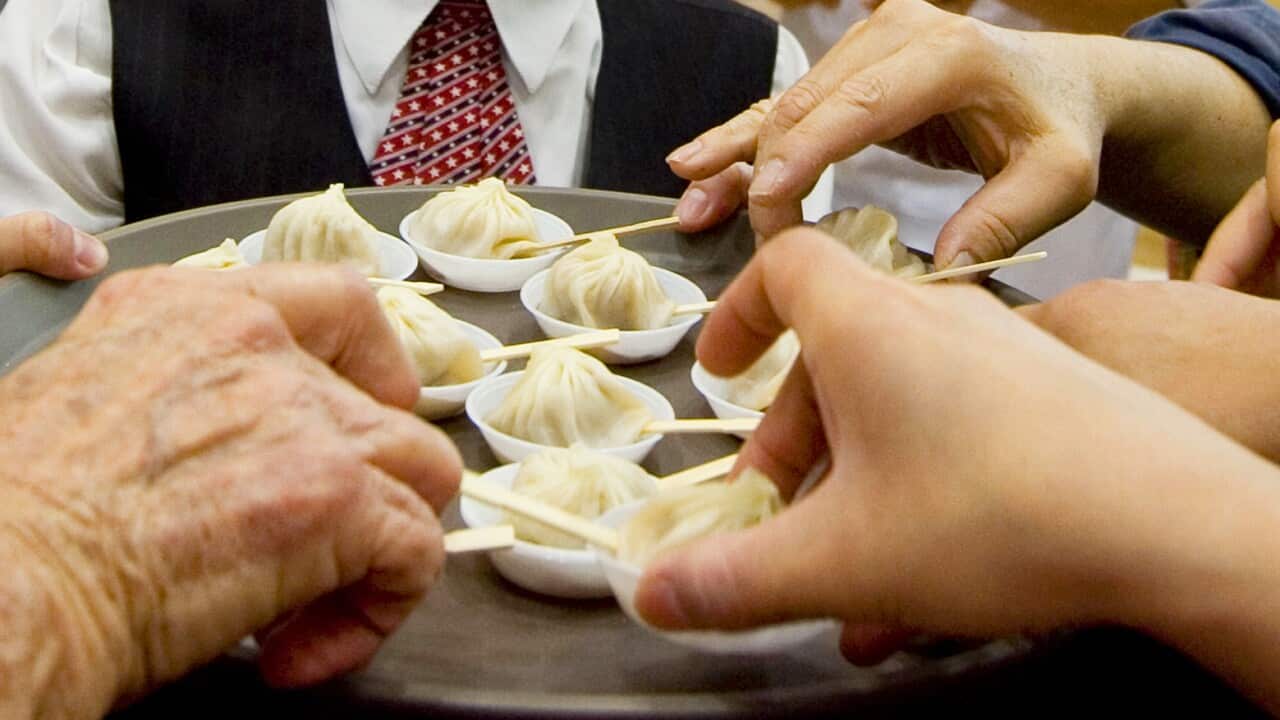 People sample hand made dumplings