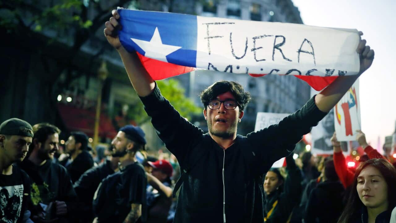 People protest against the situation in Chile, in front of the country's consulate in Buenos Aires, Argentina, 21 October 2019.