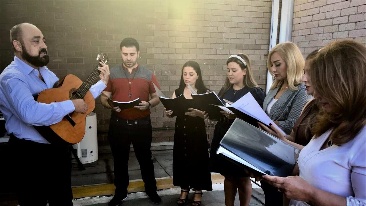 Bashar Hanna leading his choir at rehearsals.