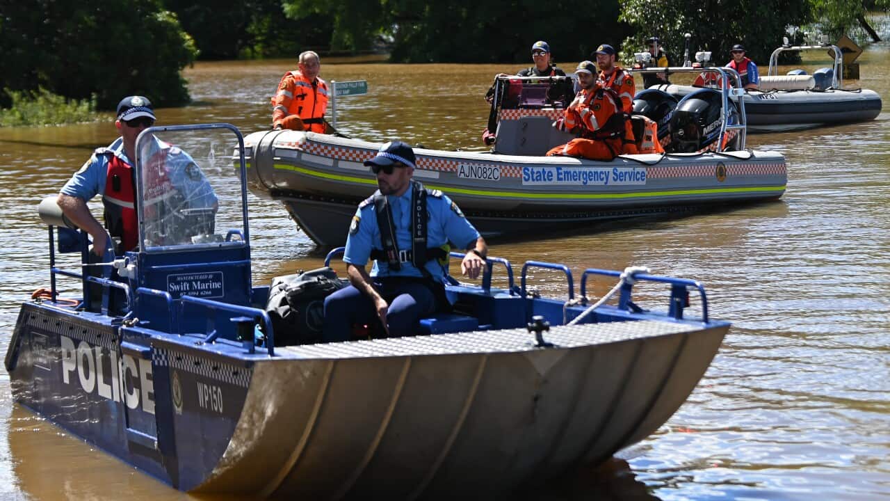 NSW State Emergency Service workers and police are seen in boats amid flooding in the suburb of Windsor, north west of Sydney on Wednesday.