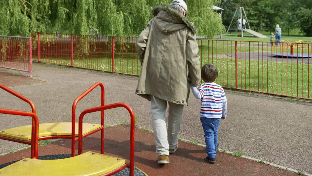 Stranger leading child out of playground