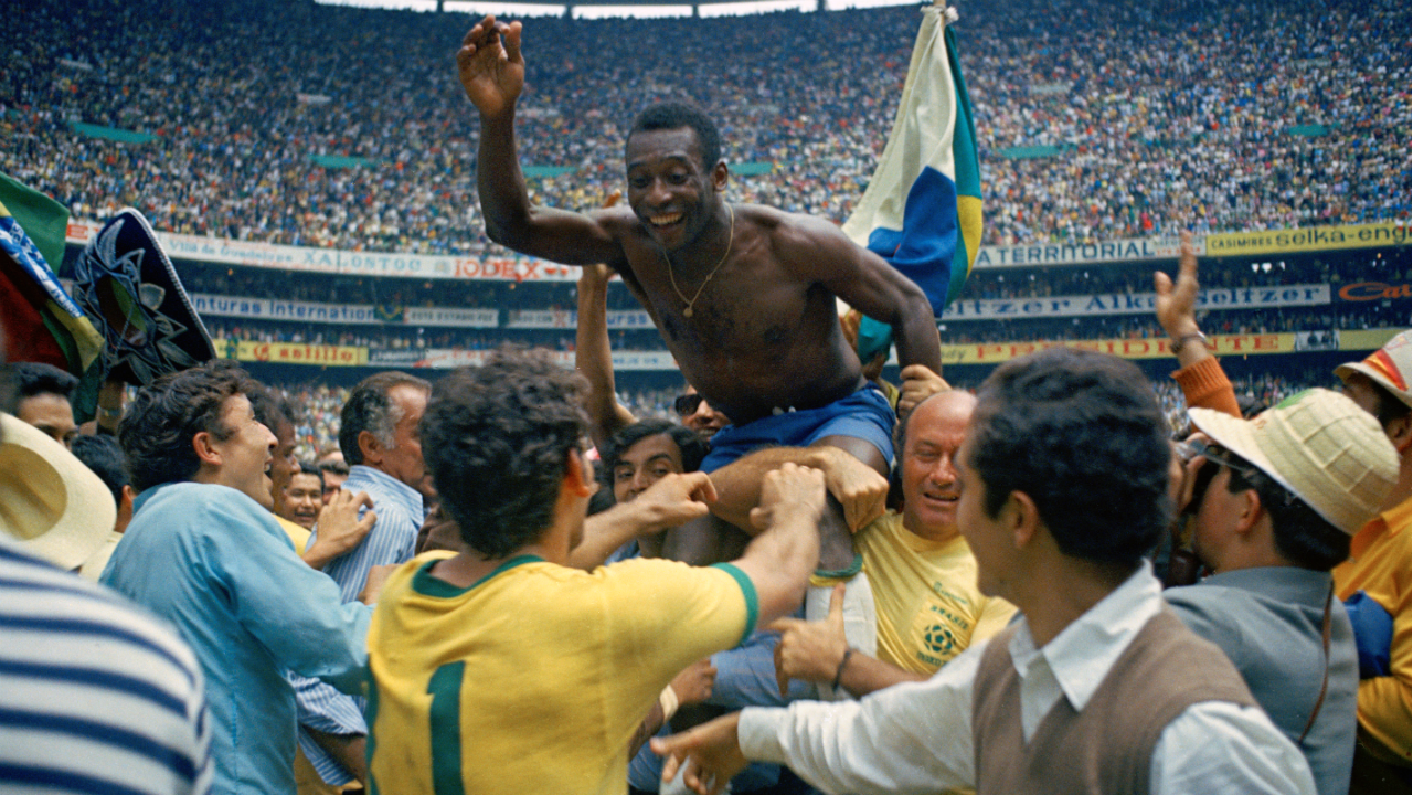 Pelé hoisted into the air after Brazil thrashed Italy 4-1 in the 1970 FIFA World Cup final