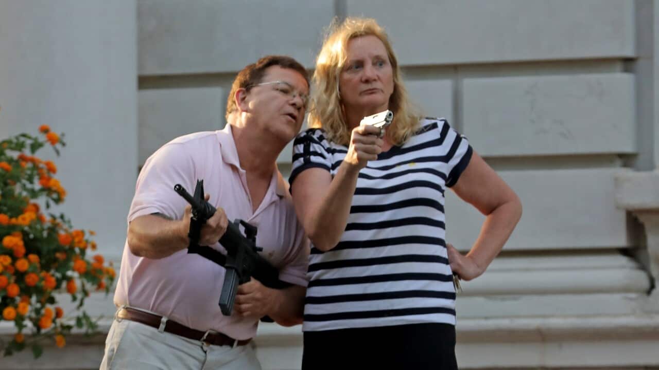 Armed homeowners, Mark T. and Patricia N. McCloskey, standing in front their house along Portland Place as they confront protesters